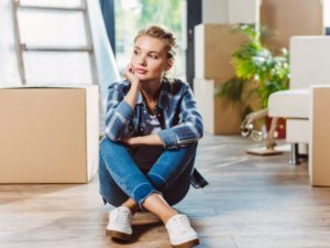 Attractive girl in room full of boxes