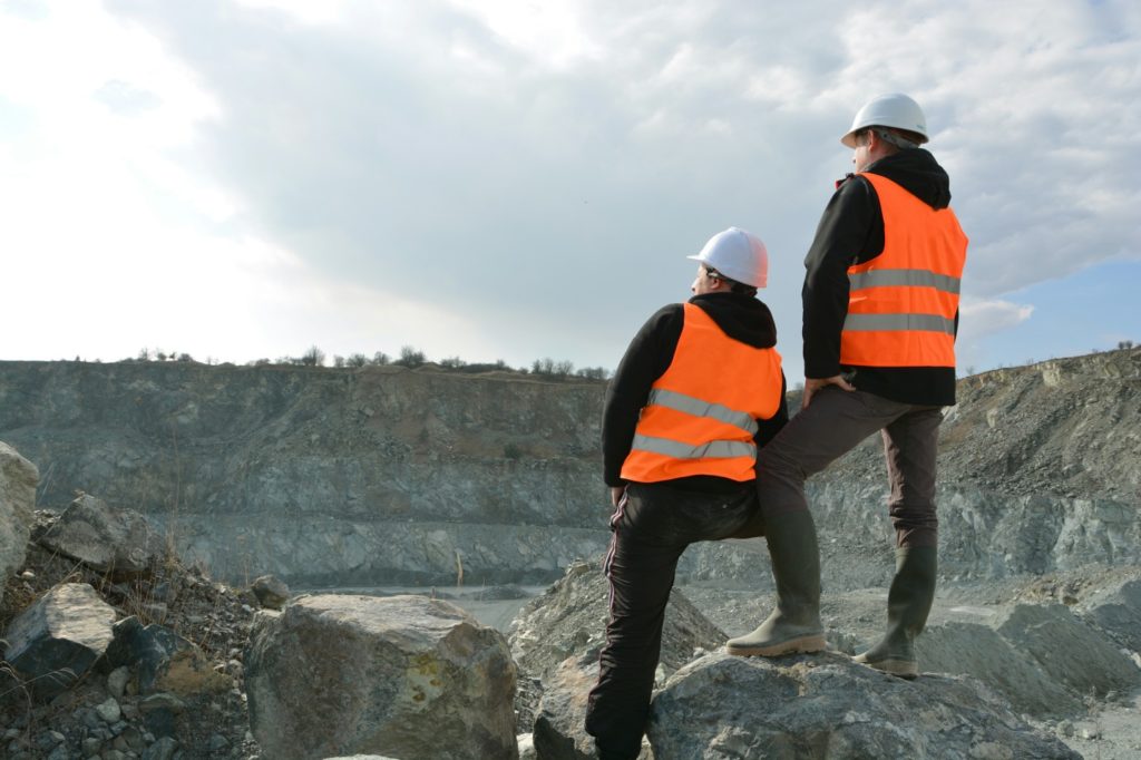 Two workers and quarry in background