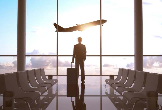 Man in the airport with plane taking off 