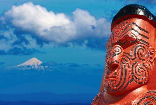 Traditional maori carving and Taranaki Mount, New Zealand