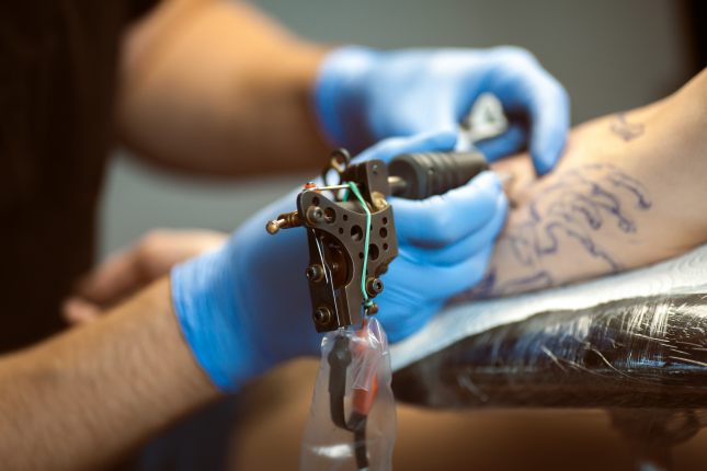 Tattooist makes a tattoo. Closeup