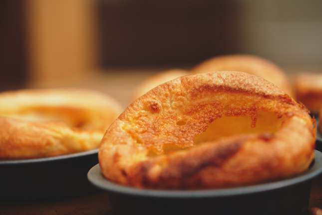 Freshly cooked Yorkshire Puddings for a Sunday roast dinner. British, English cuisine.