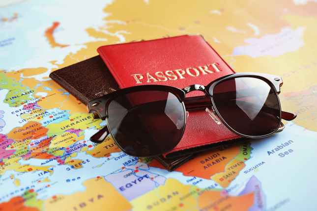 Sunglasses and passports on map