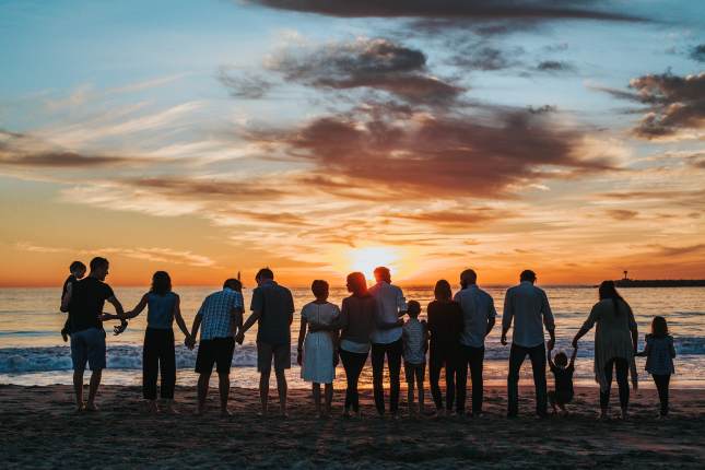 Family on the beach at sunset