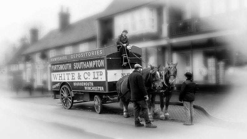 A horse-drawn White & Co. Ltd removal carriage for Hampshire Depositories, with its driver and two horses